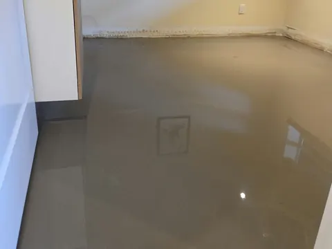 Small room with a vanity, self-levelling compound poured around it
